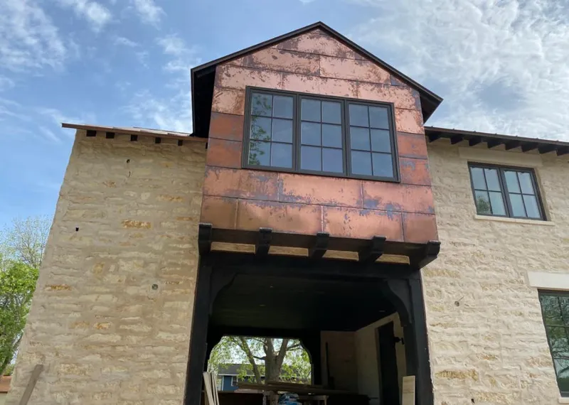 Copper metal panel facade on a stone building for Metal Roof Coating in Prairie Grove