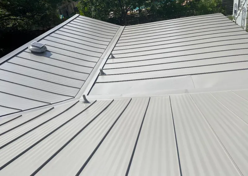 Solar attic fan installed on a metal roof for Roof Ventilation in Prairie Grove